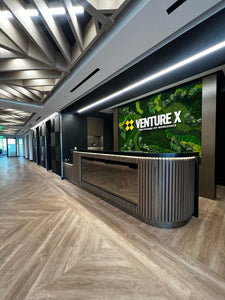 A sophisticated commercial interior with a large preserved moss wall installation and a customized moss logo art. This moss wall is for a coworking space - Venture X in Virginia. 