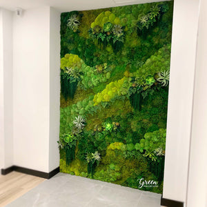 Modern interior space featuring a large preserved moss wall with various textures and shades of green, incorporating elements from Amazonia collection (preserved moss and ferns with faux succulents).